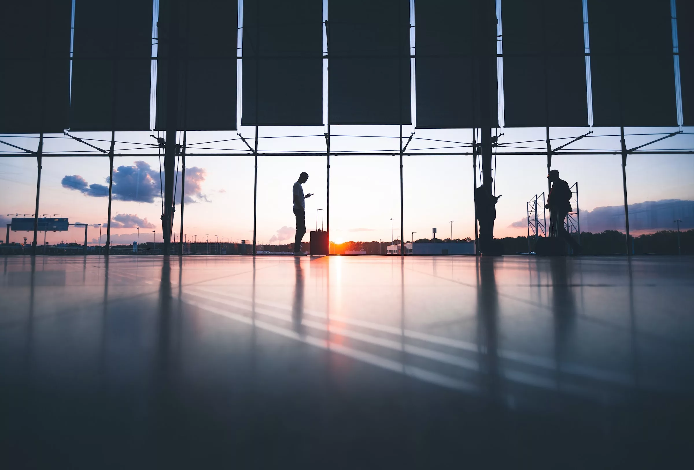 Business man waits at airport using webapp